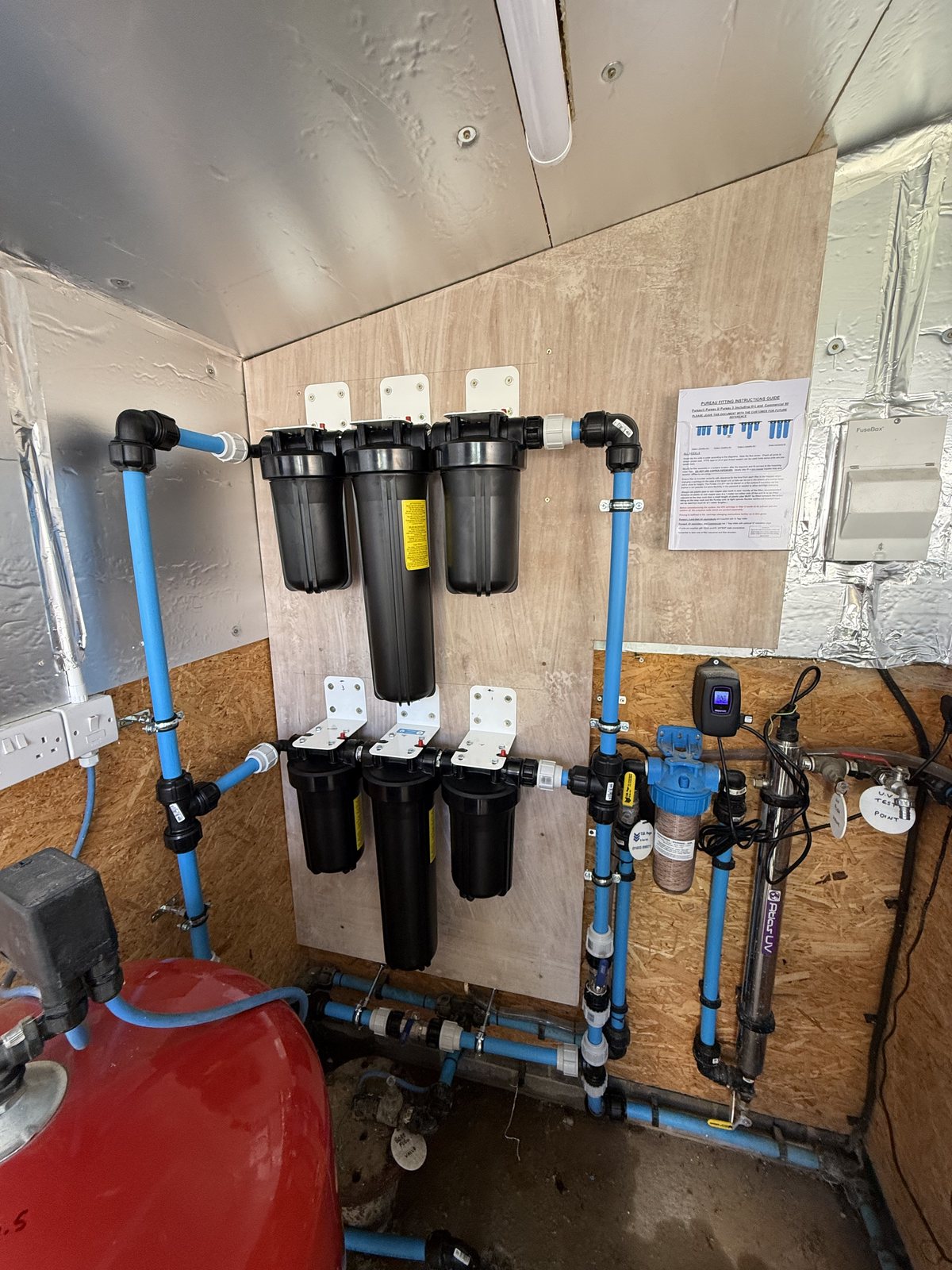Aquatiere multi-stage whole-house water filtration system in a plant room, installed by Precision near Norwich