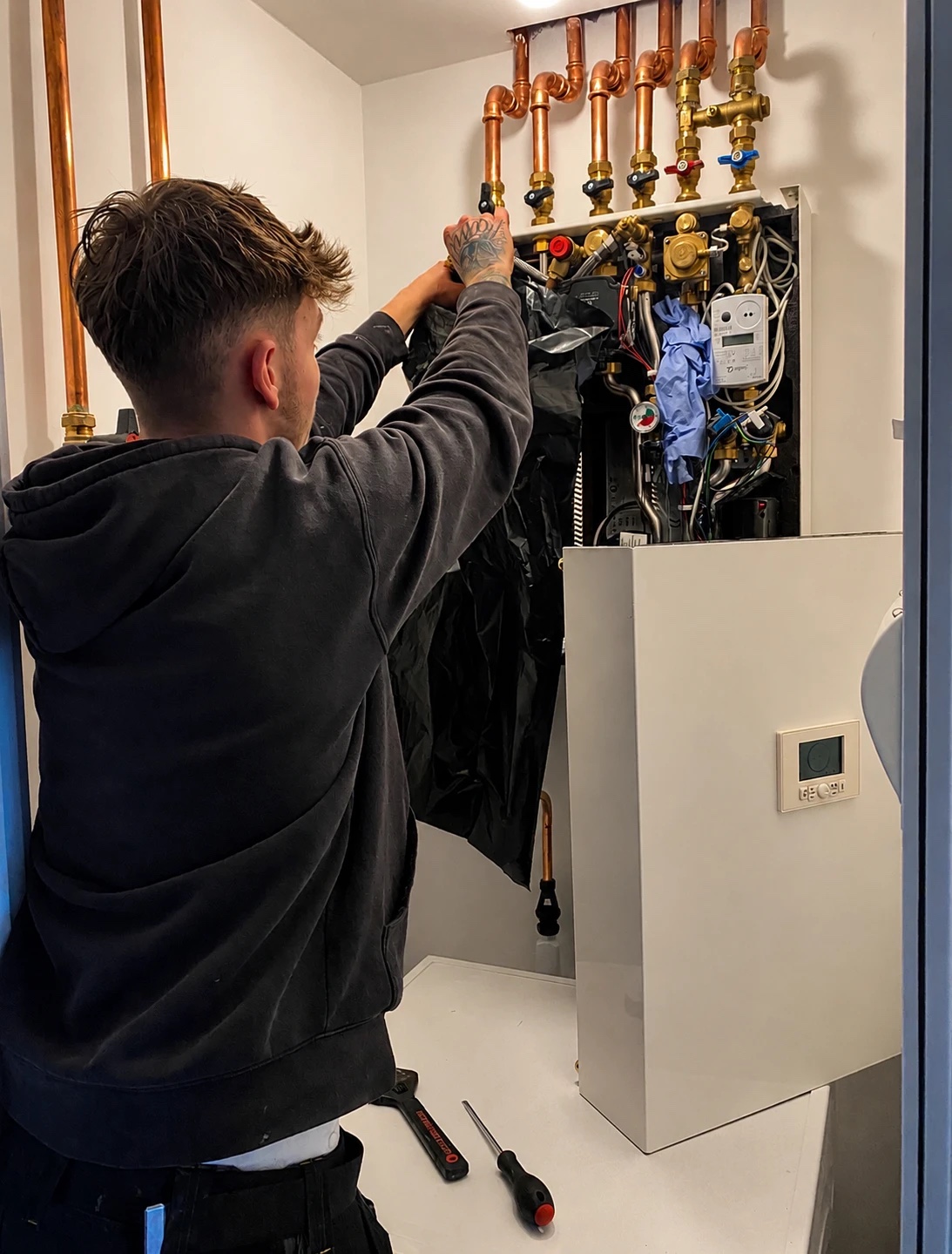 Precision engineer working on a heating system