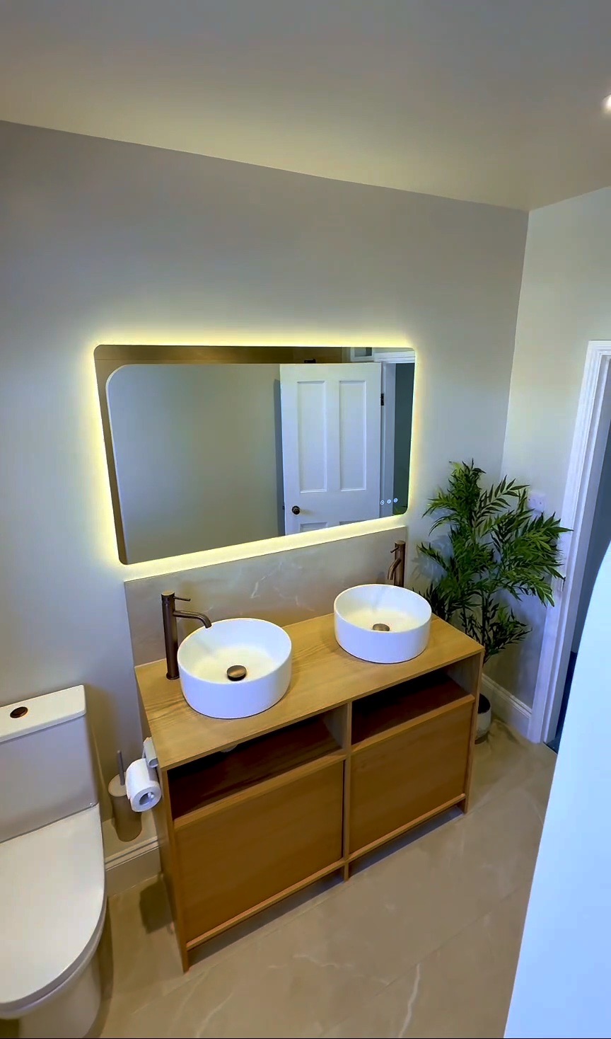 Walk-in wet room with stone-effect porcelain and brushed-bronze shower
