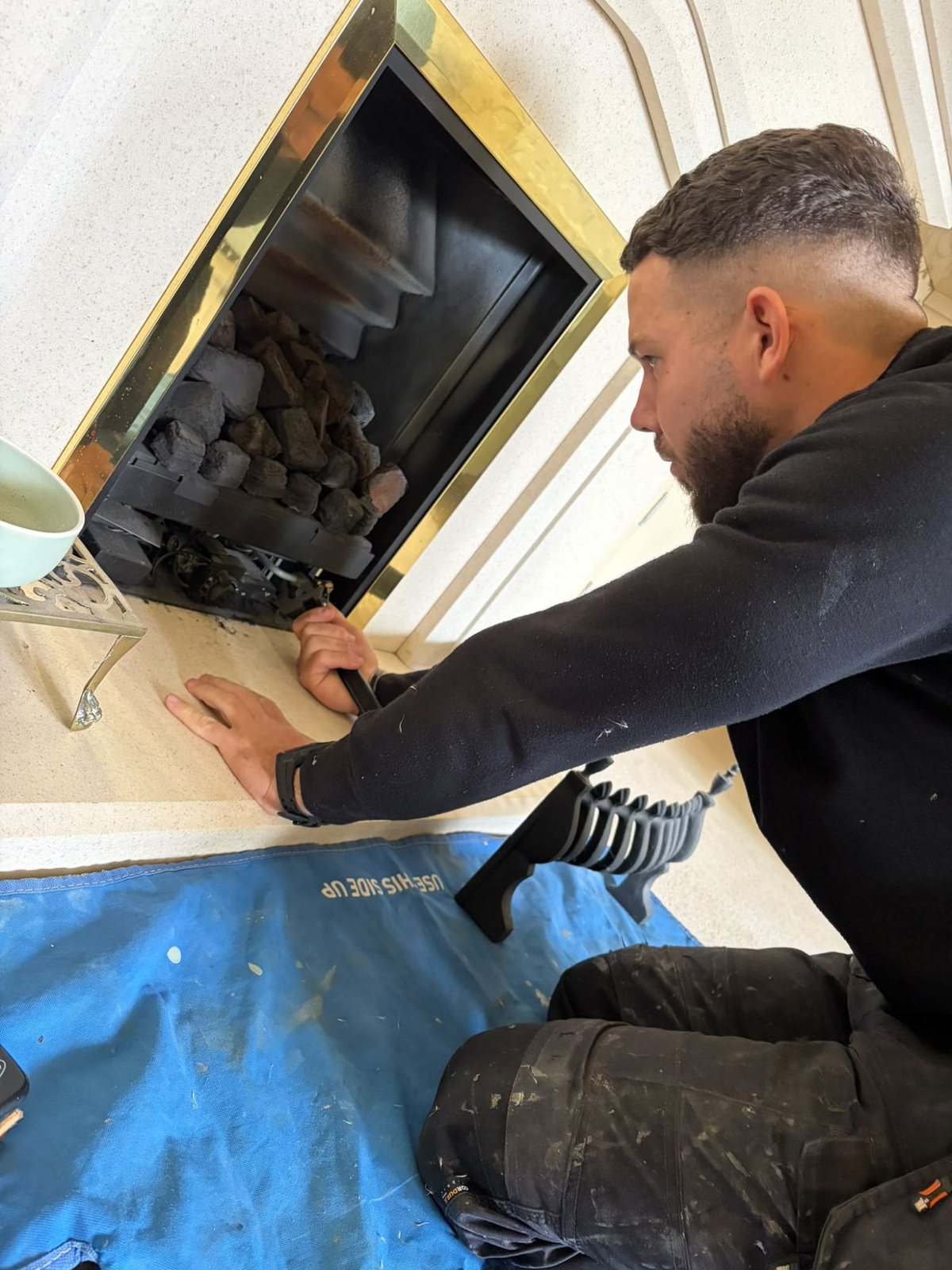 Precision engineer servicing a gas fire